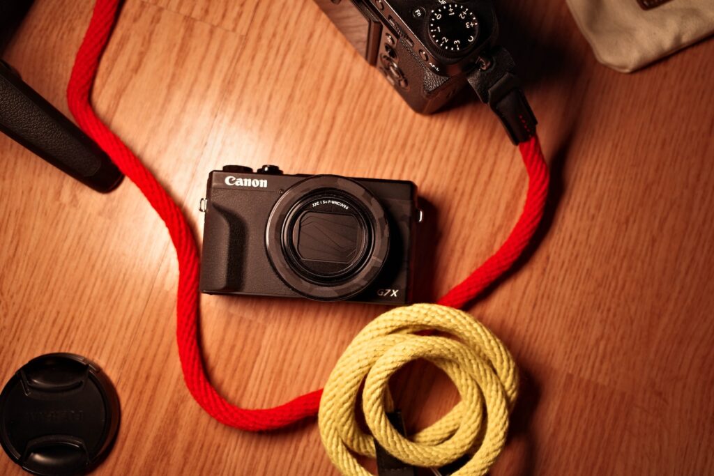 black nikon dslr camera on brown wooden table