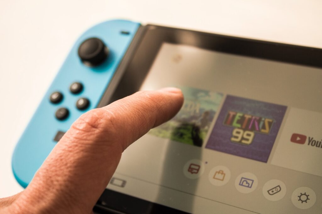 person touching Nintendo Switch